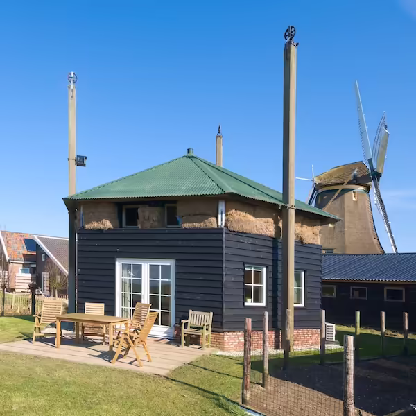 Haystack house with terrace; the windmill in the background